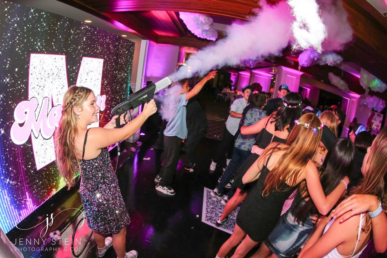Guests celebrating on a dance floor with a handheld party effect
