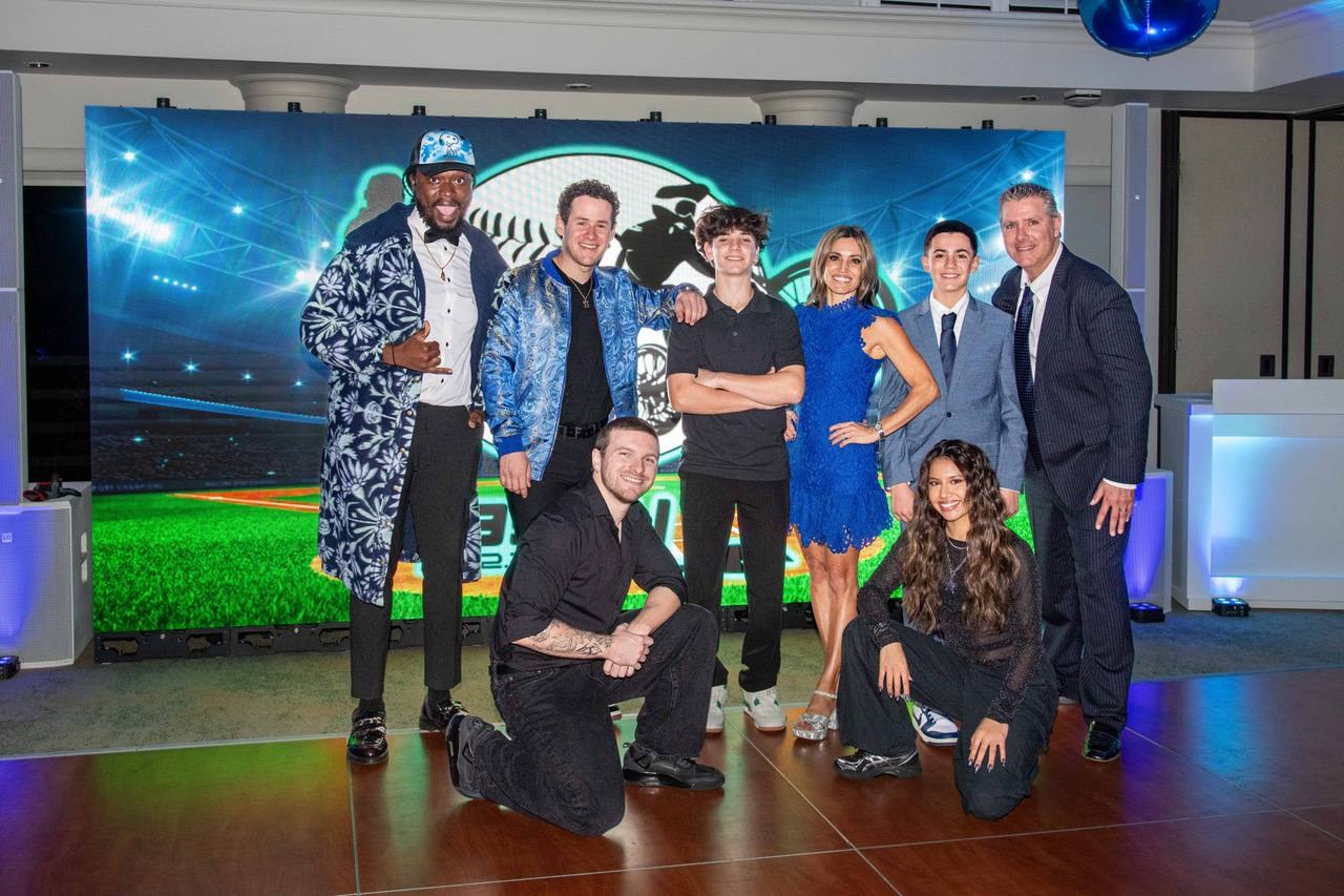 Event team posing together in front of an LED video wall